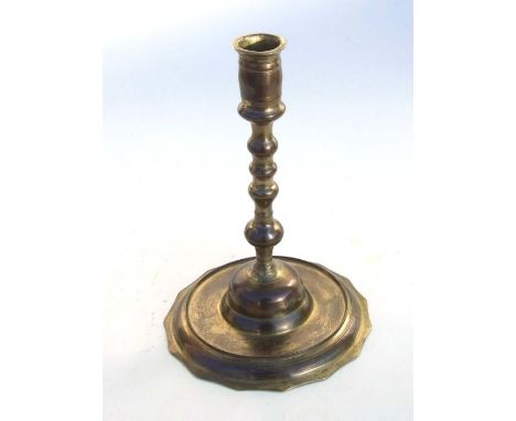 An Ottoman brass candlestick with traces of gilding, 24cms high.