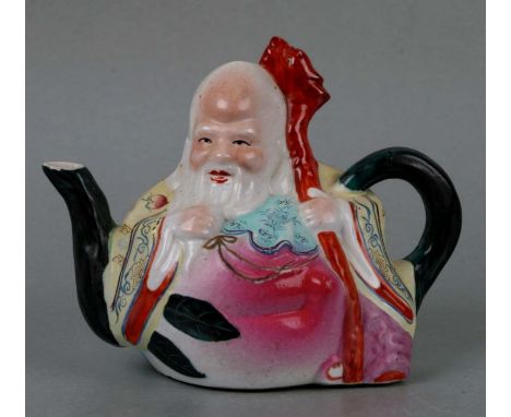 A Chinese Republic period Shoulau teapot in the form of a peach and sage figure, 17cms wide.