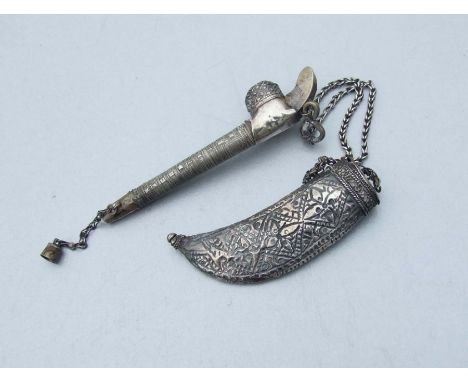 A Middle Eastern white metal pipe and scabbard shaped tobacco container joined by a double chain, pipe length 15cms.