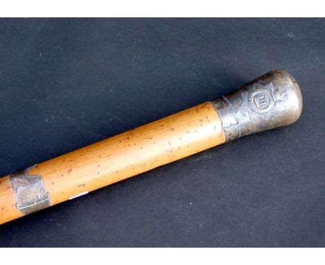 A Malacca walking stick with East Sussex Regiment pommel, 91cms long.