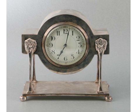 A silver plated cased mantle clock on lion mask supports, the white dial with Roman numerals, 19cms wide.