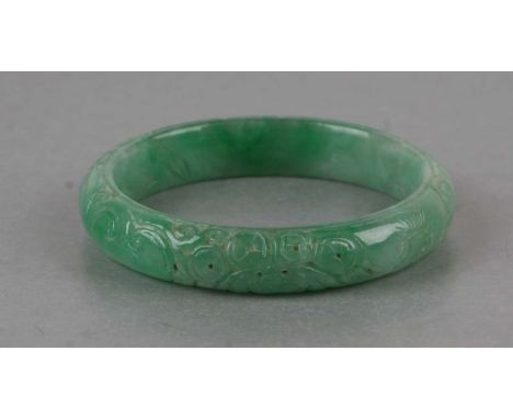 A Chinese Republic carved apple green jade bangle, 7cms diameter.Condition Reportgood overall condition, no chips or cracks