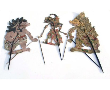 Three Thai pierced card shadow puppets. Largest overall 97cm