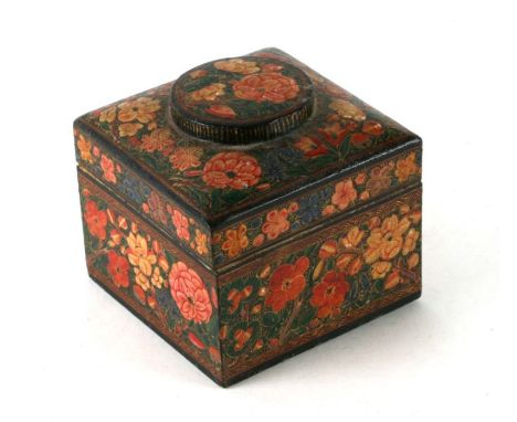 An Indian Kashmiri lacquer tea caddy of square form decorated with flowers, 10cms wide.