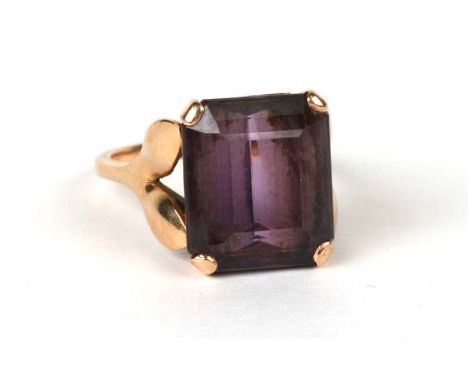 A yellow metal mounted (tests as gold) cocktail ring set with a large square amethyst, approx UK size 'P', 7.4g.