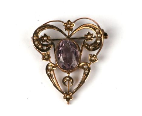 An Edwardian 9ct gold brooch, Suffragette colours set with a large oval amethyst and seed pearls.