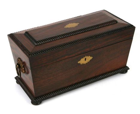 A Regency rosewood tea caddy of sarcophagus form with fitted interior with two tea canisters and cut glass mixing bowl, reede