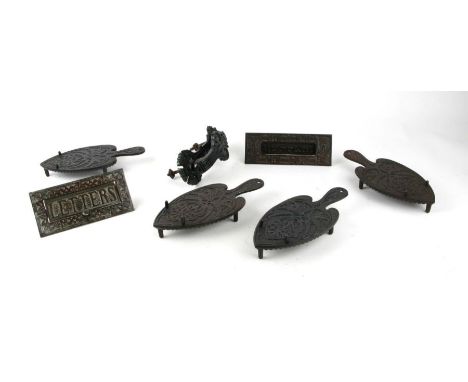 A group of Christopher Dresser design Kenrick &amp; Sons items to include four iron stands, two letterboxes and a door knocke