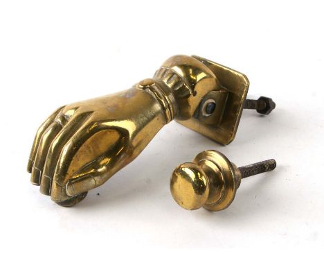 A brass hinged door knocker in the form of a ladies hand, 15cms long.Condition ReportMeasures 6cms wide and has age to it, no