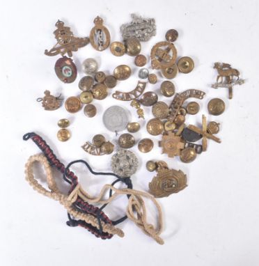 A collection of assorted WWII Second World War and other war period British Military cap badges and uniform buttons. Examples