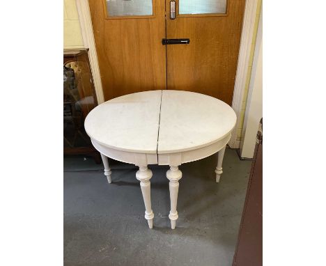 A pair of white painted demi-lune console tables on turned supports, width 118cm.