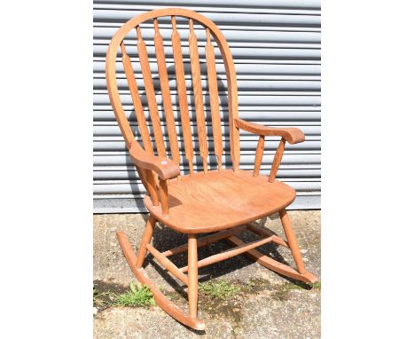 A modern light oak rocking chair.