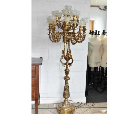 An ornate gilt metal 15 branch standard lamp decorated with cherubs, height 177cm.