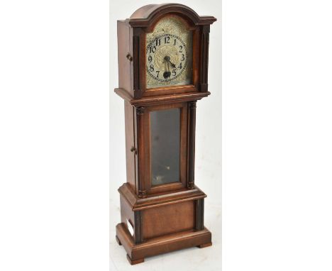 A miniature longcase clock, height 34cm, with pendulum and key.