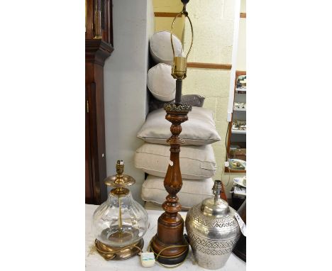 A large modern glass lamp, metal lamp and another with shade.