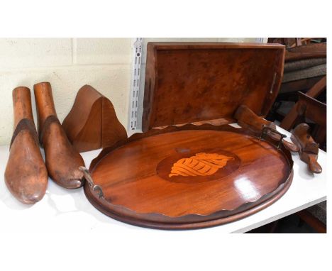 An oval mahogany inlaid tray with shell motif, a square walnut tray, a pair of wooden shoe stretchers, a pair of wooden booke