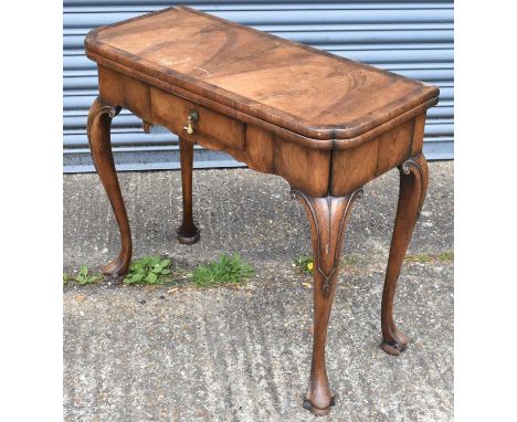 An 18th century walnut card table, with crossbanded top above frieze drawer on cabriole single gateleg supports, width 84.5cm
