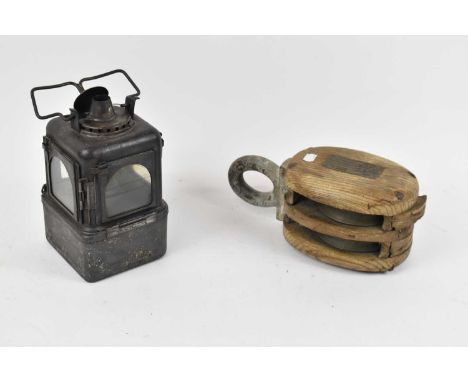 A vintage black painted ships lamp and a ships pulley.