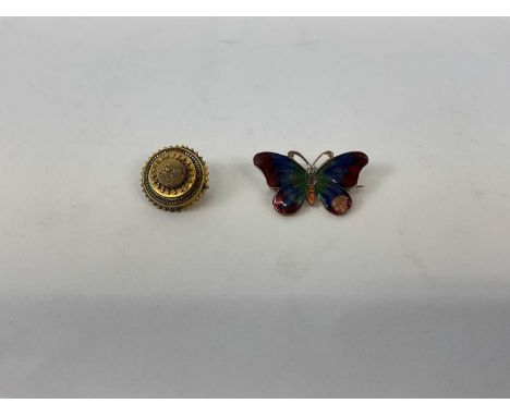 A Victorian style yellow metal target brooch, and an enamel brooch modelled a butterfly.Condition Report: Chip to the enamel.