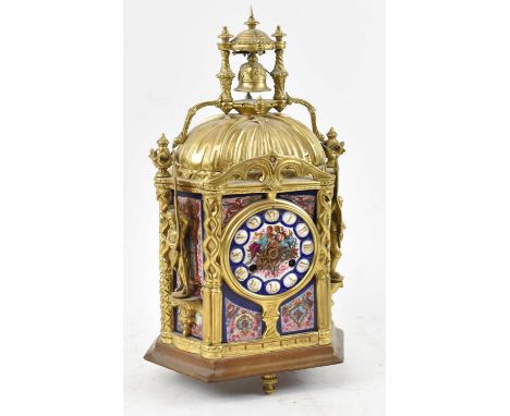 A late 19th century French gilt metal and porcelain mounted French eight-day mantel clock with elaborate canopy above circula