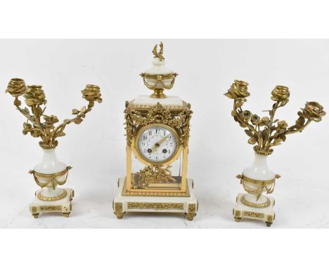 A late 19th century French white marble and gilt mounted three piece clock garniture, the eight-day mantel clock with clear g