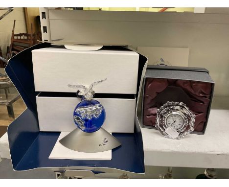 A boxed Swarovski Millennium Planet 2000 paperweight and a small boxed Waterford clock. 