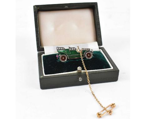 An unusual early 20th century yellow metal and green enamel brooch modelled as a vintage car, the green enamel body set with 