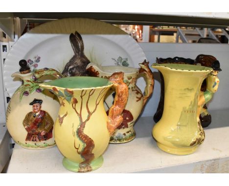 Five assorted jugs comprising a Burleigh ware Pied Piper, a John Peel musical jug with fox handle, a Burleigh ware fox handle