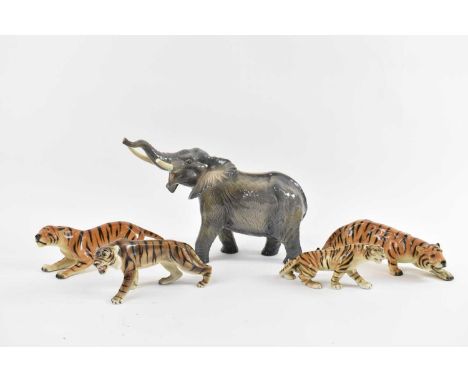 Four ceramic figures of tigers and a large elephant figure (af), height 25.5cm (5).