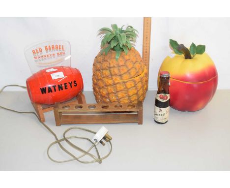 A retro peach and pineapple ice bucket, Watneys Red Barrel bar ornament, a pipe stand and a vintage bottle of Cherry B