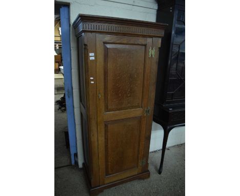 A Georgian style oak single door wardrobe with brass butterfly handles