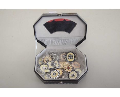 A box of various scarf pins