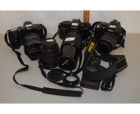 A group of cameras, a Minolta X300S, a Minolta Dynax 500SI and a Nikon D60 together with accompanying lenses