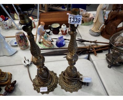 Two brass lamps, with floral design. All electrical items in this lot have been PAT tested for safety and have passed. This d