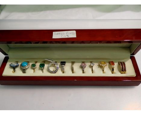 Wooden case containing 12 stone set dress rings. UK P&amp;P Group 1 (£16+VAT for the first lot and £2+VAT for subsequent lots