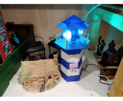 Two solar lights and a light house with working lights. All electrical items in this lot have been PAT tested for safety and 
