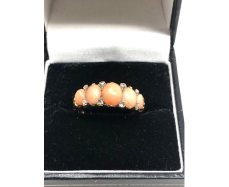 An antique 18ct gold opal &amp; rose diamond ring with five coral cabochons, with small rose   diamond highlights 