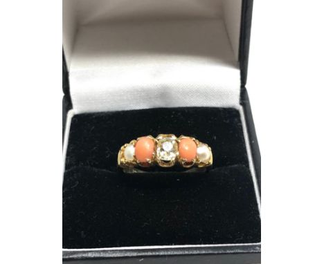An 18 carat gold opal coral &amp; old cut diamond ring  with pearls coral with central old cut diamond dia that measures appr