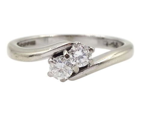 18ct white gold two stone round brilliant cut diamond crossover ring, hallmarked, total diamond weight 0.25 carat Condition R