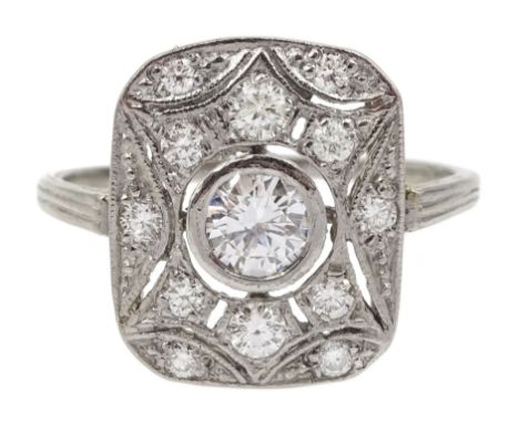 Platinum Art Deco style diamond panel ring, the rectangular curved pierced panel with a central round brilliant cut diamond o