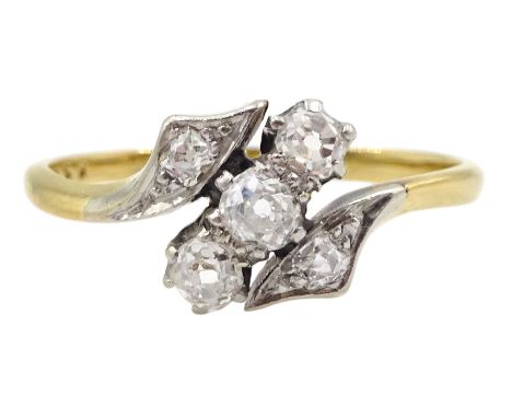 Early 20th century gold three stone old cut diamond crossover ring with diamond set shoulders, stamped 18ct PtCondition Repor