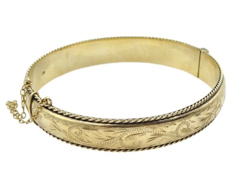 9ct gold hinged bangle with engraved and rope twist decoration, hallmarked Condition Report:Approx 14gm, clasp secure, depth 