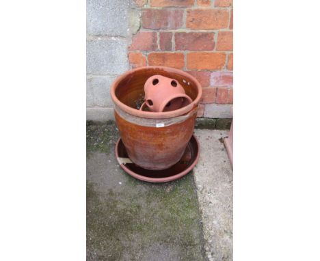 A large lead glazed terracotta planter and other garden planters and pots
