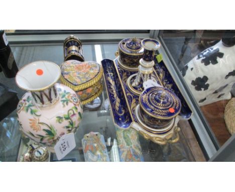 An 1830s Bloor Derby porcelain inkstand, with central taper stick holder, seal pot and cover, and inkwell cover, on a twin ha