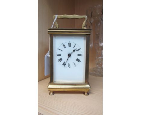 A brass four-glass carriage timepiece, the eight-day movement faced by enamel Roman dial