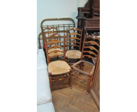 A set of four Arts and Crafts design Edwardian walnut ladder back side chairs, with woven rush seats over turned under frame 