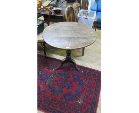 A George III oak circular snap top tripod, wine table with simple cabriole supports