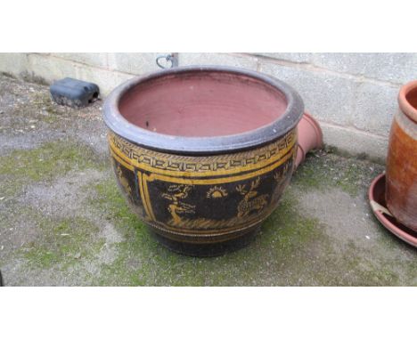A large oriental style tree planter with slip decoration