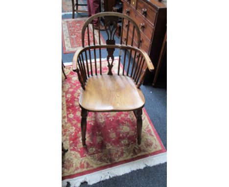 A 19th century double hoop and stick back yew Windsor armchair with elm seat on turned splayed tapering supports