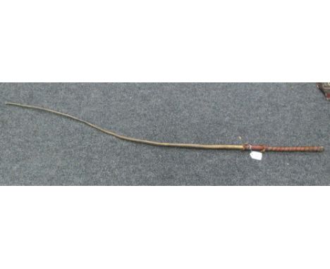 A sapling wood bull whip with leather bound handle